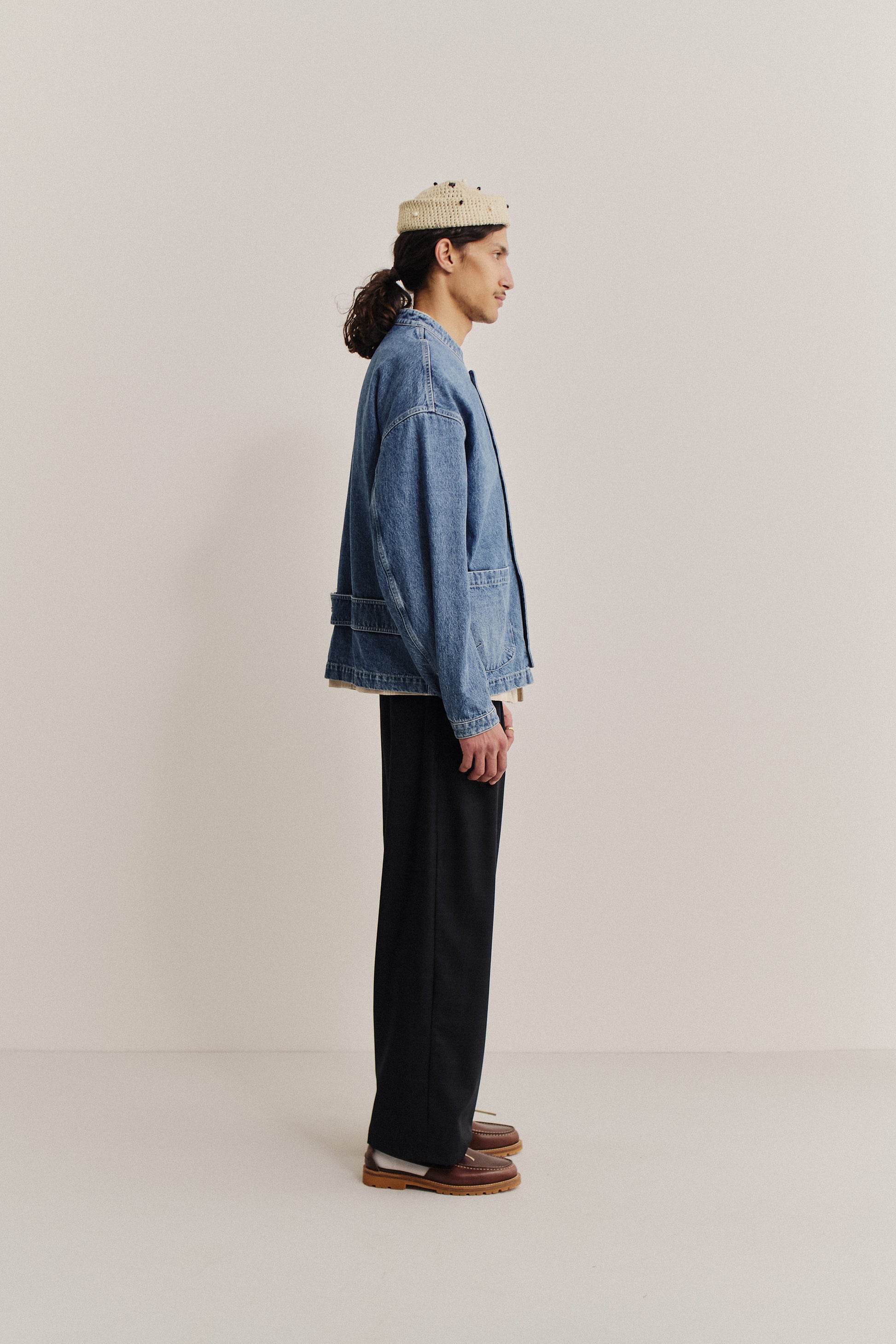 Men's outerwear denim jacket, stone washed indigo, with patch pockets and stand collar.