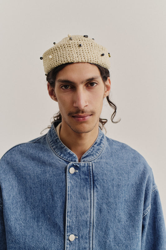 Men's outerwear jacket, washed indigo denim, with a stand-up collar and buttoned cuffs.