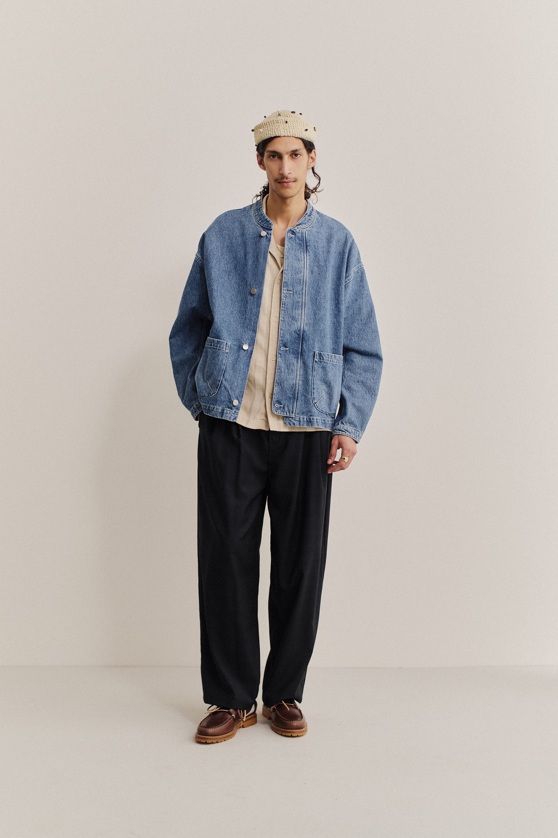 Men's outerwear denim jacket, stone washed pure indigo, with stand-up collar and patch pockets.