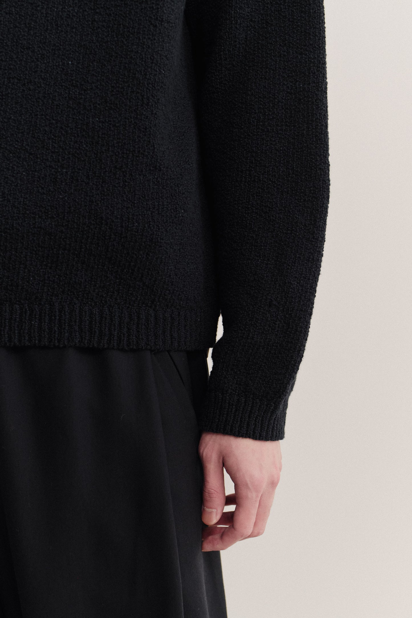 Men's knit long-sleeved polo, black 100% organic cotton bouclé, relaxed fit with ribbed trims.
