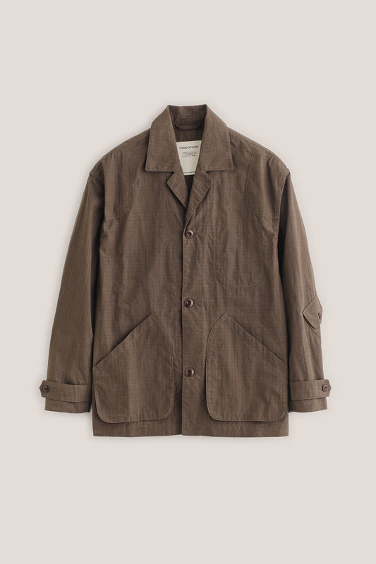 Men's outerwear jacket, brown cotton blend ripstop, vintage-style lapel, patch pockets, corozo buttons.