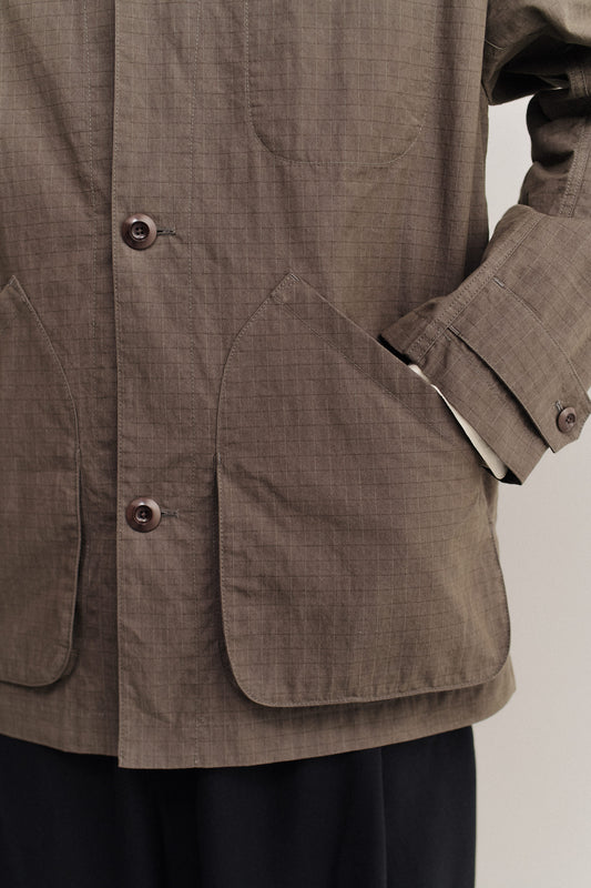 Men's outerwear jacket, cotton blend ripstop, waxed finish, brown, with patch pockets and corozo buttons.