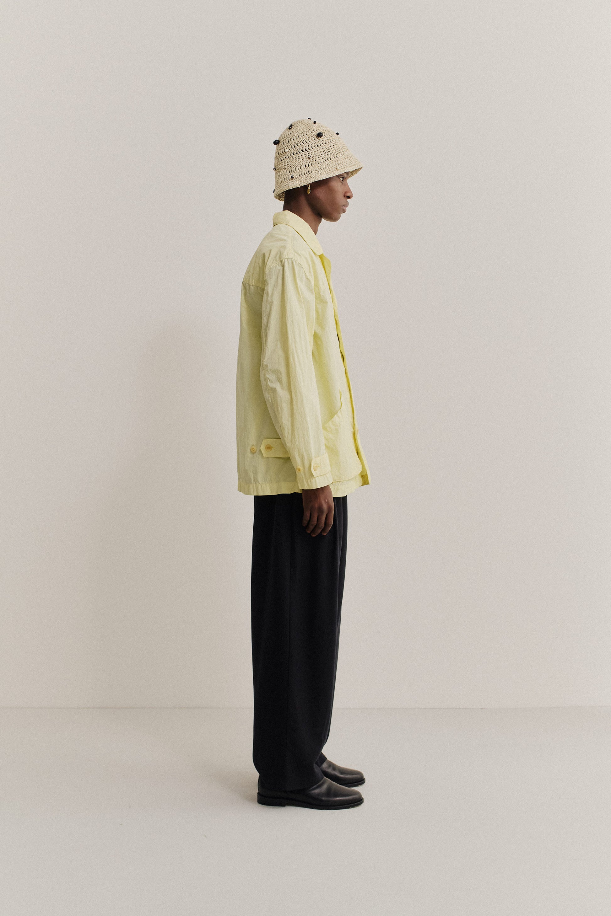 Men's outerwear jacket, recycled polyamide, garment-dyed washed light yellow, with vintage lapel and patch pockets.