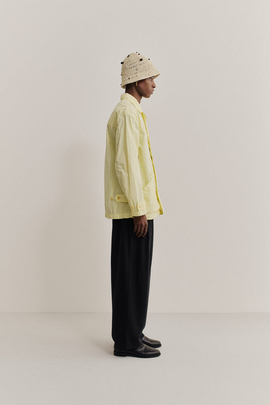 Men's outerwear jacket, recycled polyamide, garment-dyed washed light yellow, with vintage lapel and patch pockets.