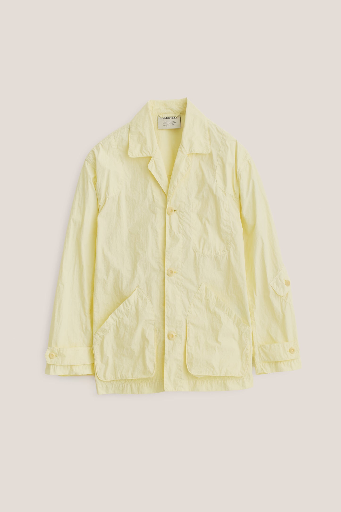 Men's outerwear jacket, recycled polyamide, garment-dyed washed light yellow, vintage-style lapel, patch pockets.