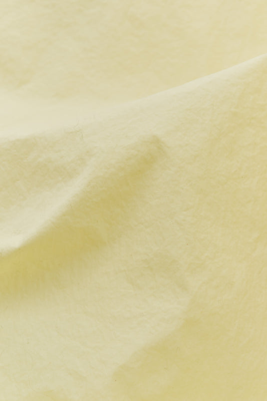 Men's outerwear jacket, recycled polyamide, garment-dyed washed light yellow.