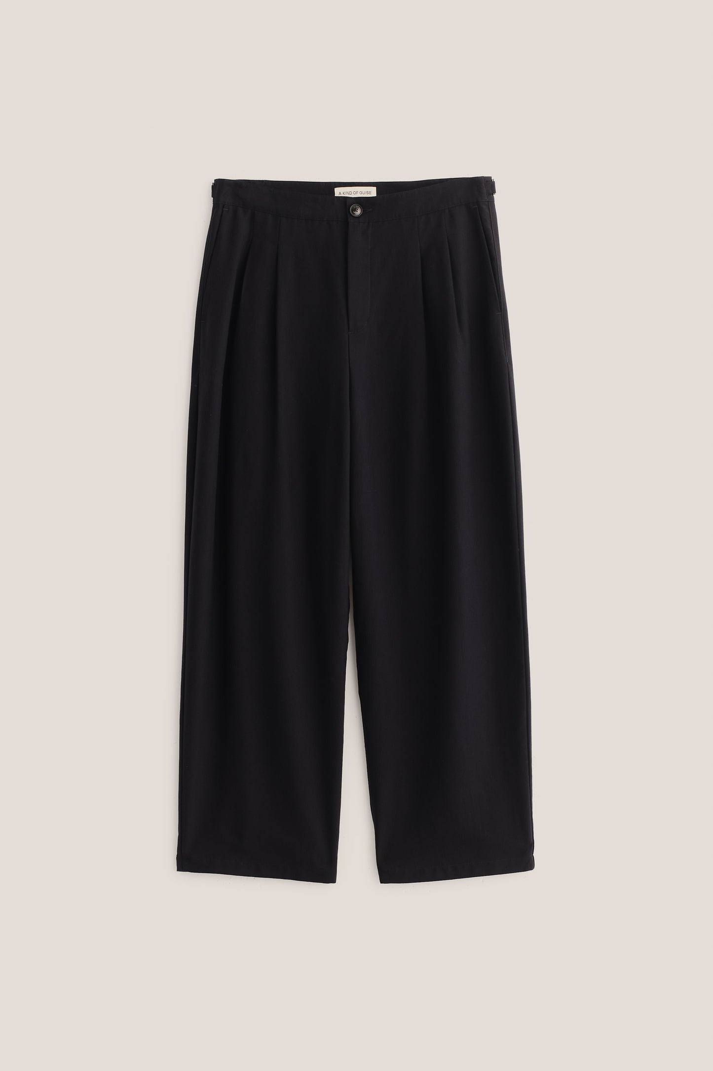 Men's long pants, black heavy lyocell twill, relaxed fit, wide leg, double pleats, and adjustable side straps.