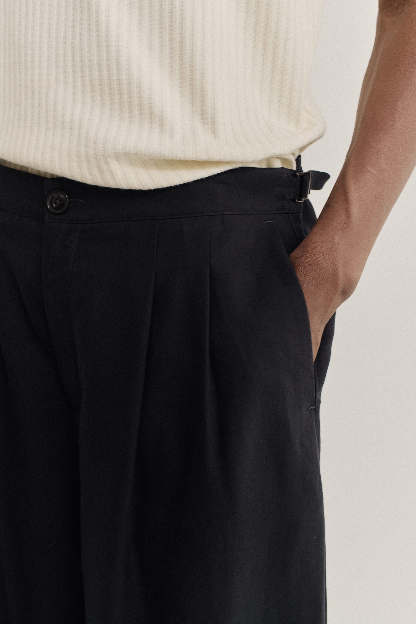 Men's long pants, lyocell heavy twill, deep black, with double pleats and adjustable side straps.
