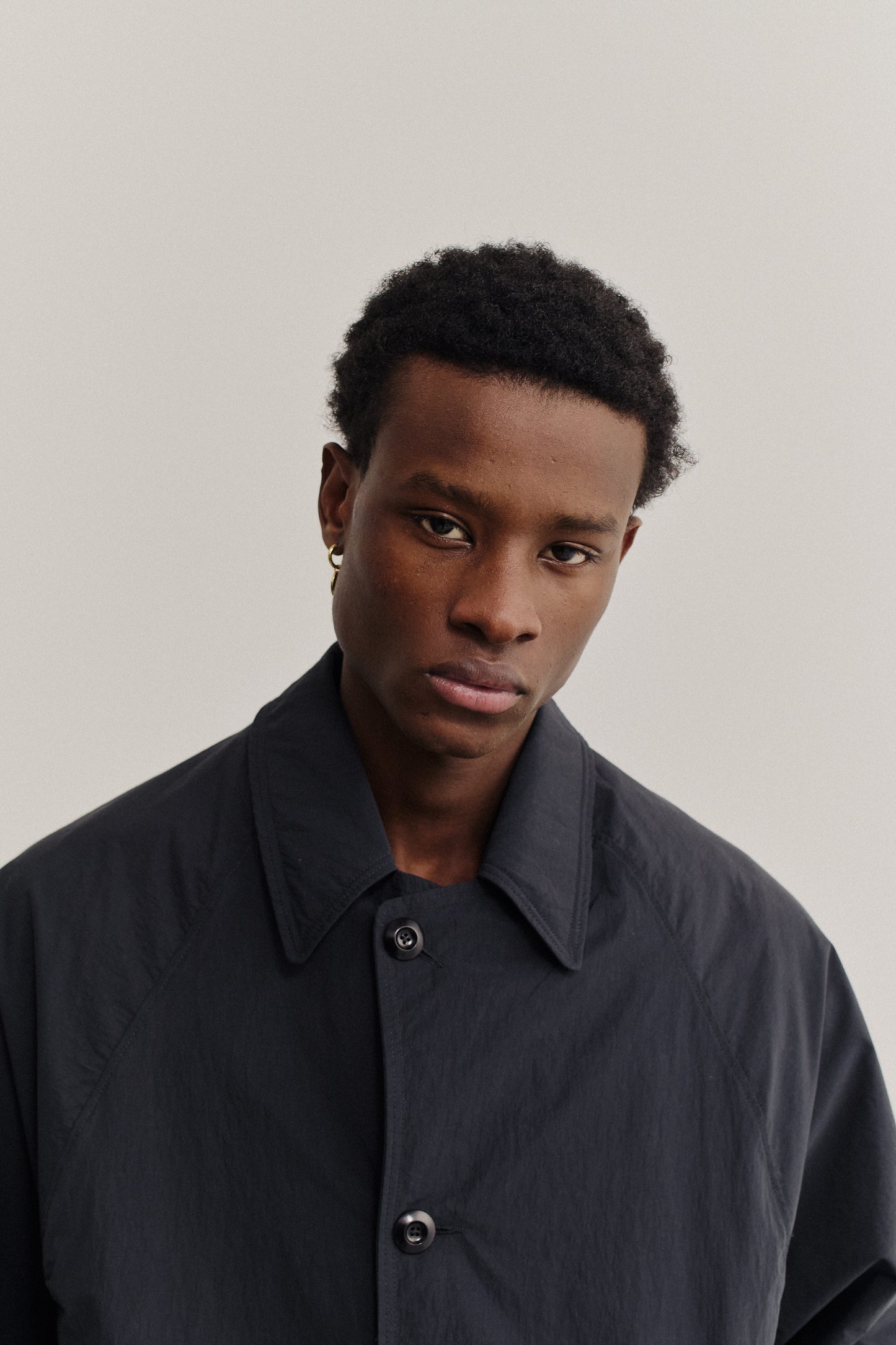 Men's outerwear, oversized water-repellent recycled nylon and cotton blend Serrara Mac in black, with reverse collar.