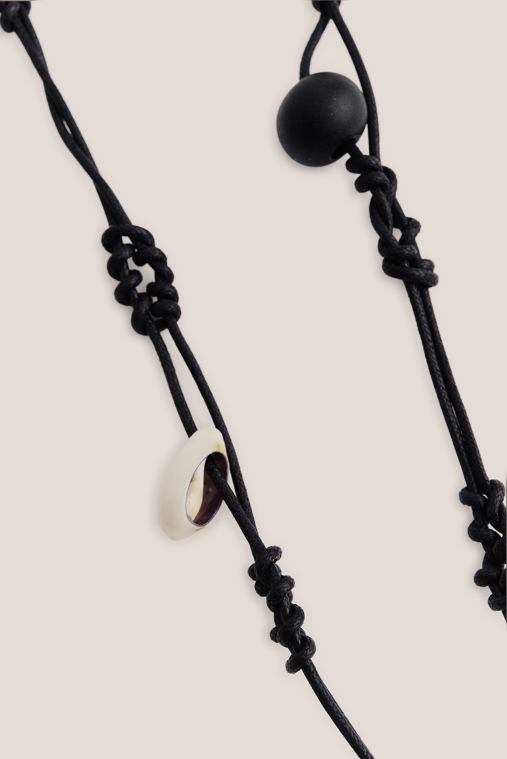 Women's accessories keychain, black leather and cotton macramé with a white shell and black wooden bead.