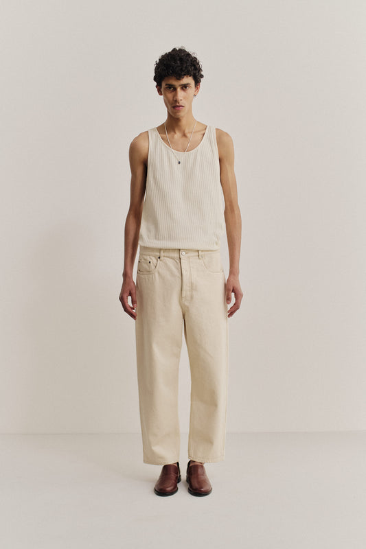 Men's long-pants, organic cotton raw denim, pre-washed off-white Terek Jeans with a loose fit and tapered leg.