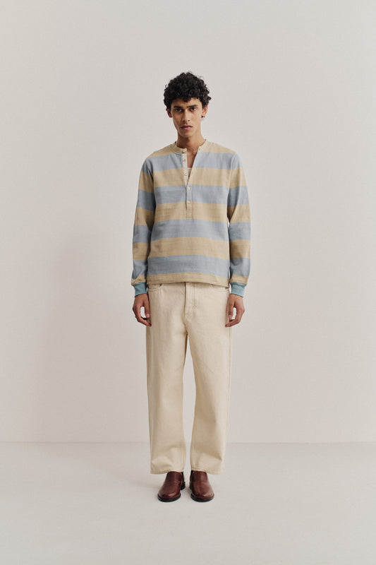Men's long-pants, organic cotton raw denim, off-white, loose fit, tapered leg, cropped length.
