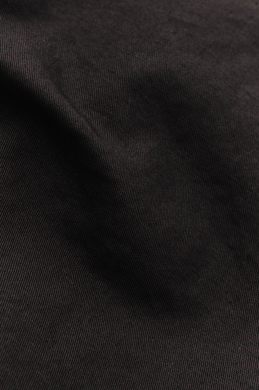 Men's long-pants, linen and cotton blend, garment-dyed deep black with textured surface.