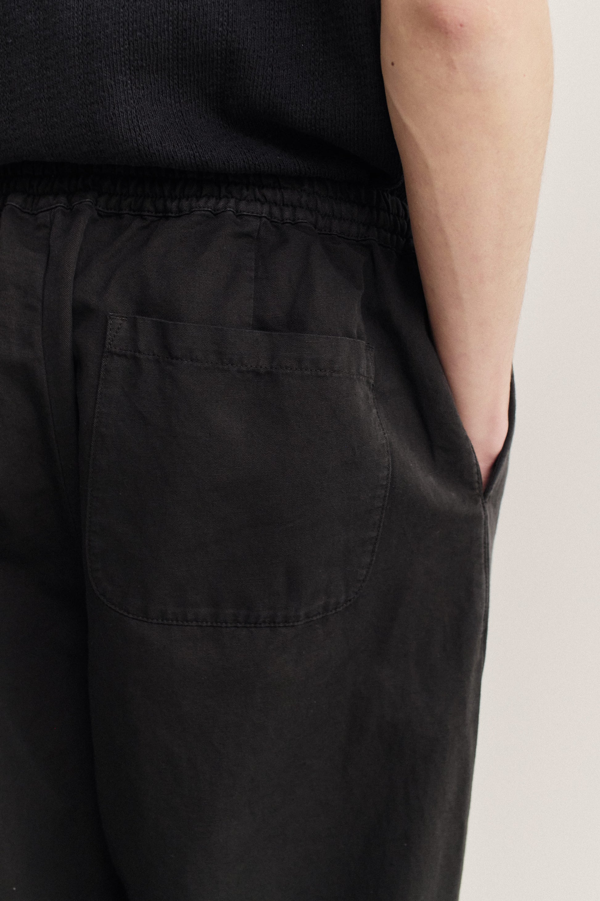 Men's long-pants, linen-cotton blend, garment-dyed black, with elastic waist and back patch pocket.