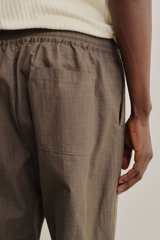 Men's long-pants, cotton blend ripstop, brown, with elastic waist and back patch pocket.