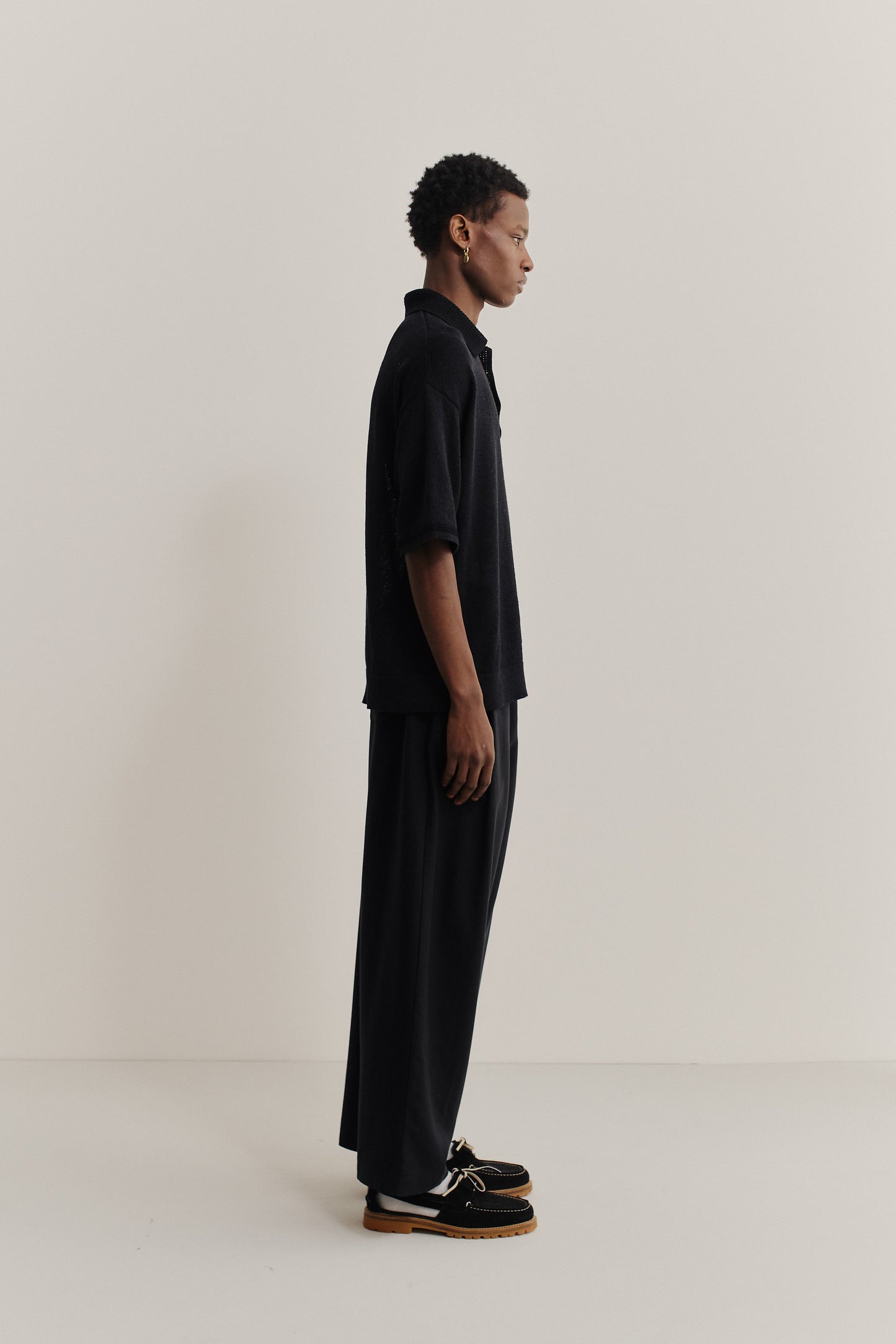 Men's knit short-sleeved polo, linen-organic cotton blend, black, oversized fit, spread collar.