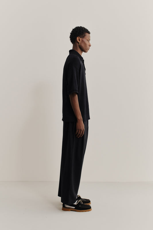Men's knit short-sleeved polo, linen-organic cotton blend, black, oversized fit, spread collar.