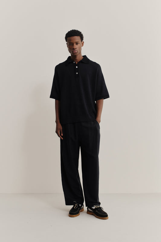 Men's knit short-sleeved polo, linen-cotton blend, black, with contrasting collar and sleeve stripe.