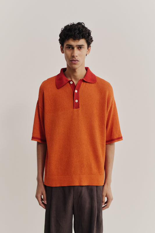Men's knit short-sleeved polo, linen-cotton blend, orange with contrasting red collar and sleeve stripe.