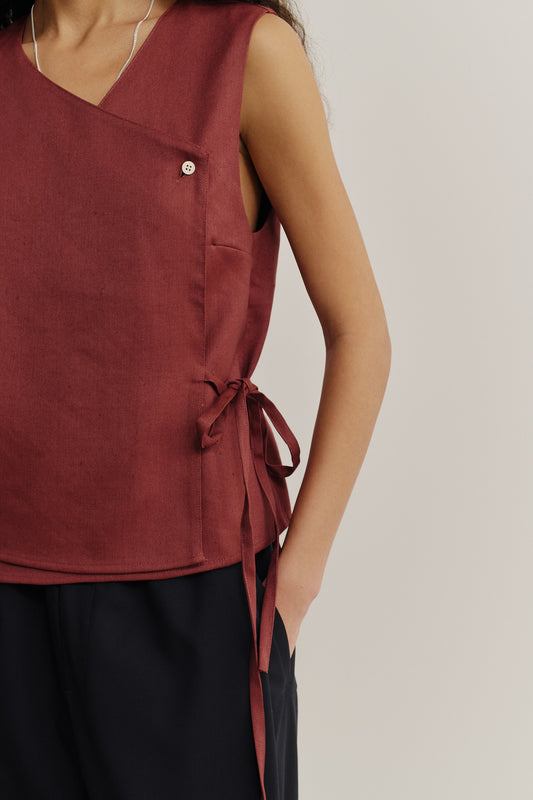 Women's sleeveless wrap shirt in linen-virgin wool-mohair blend, featuring an asymmetric front, V-neck, and side ties, in a prune color.