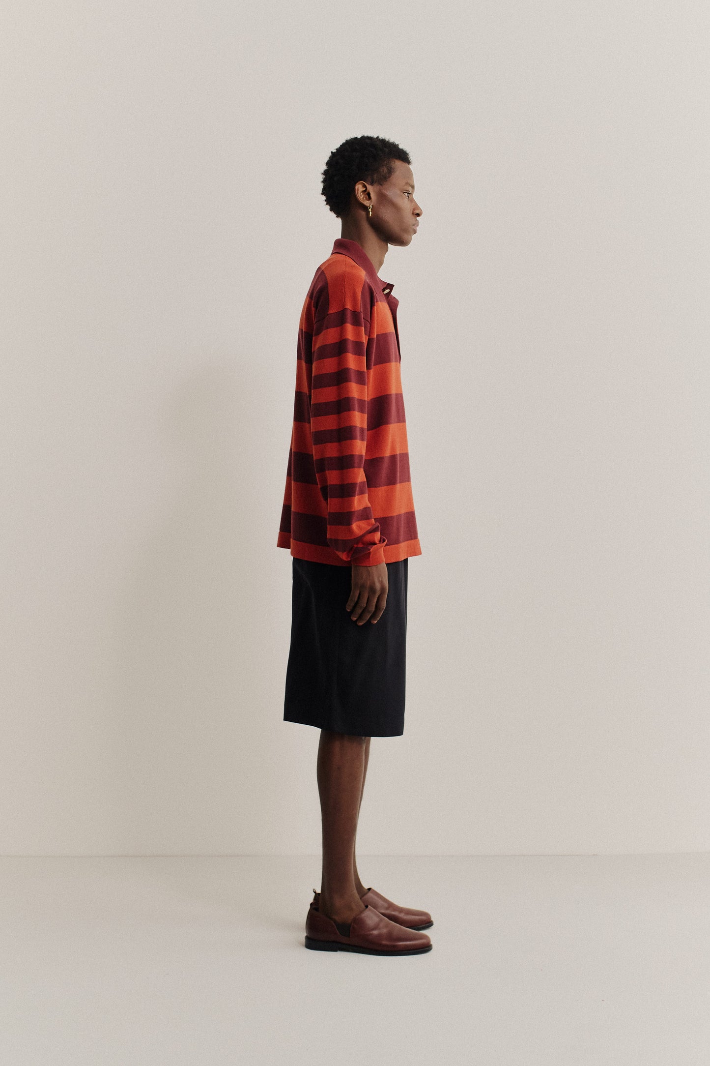 Men's knit long-sleeved polo shirt, 100% fine merino wool, red and burgundy striped.