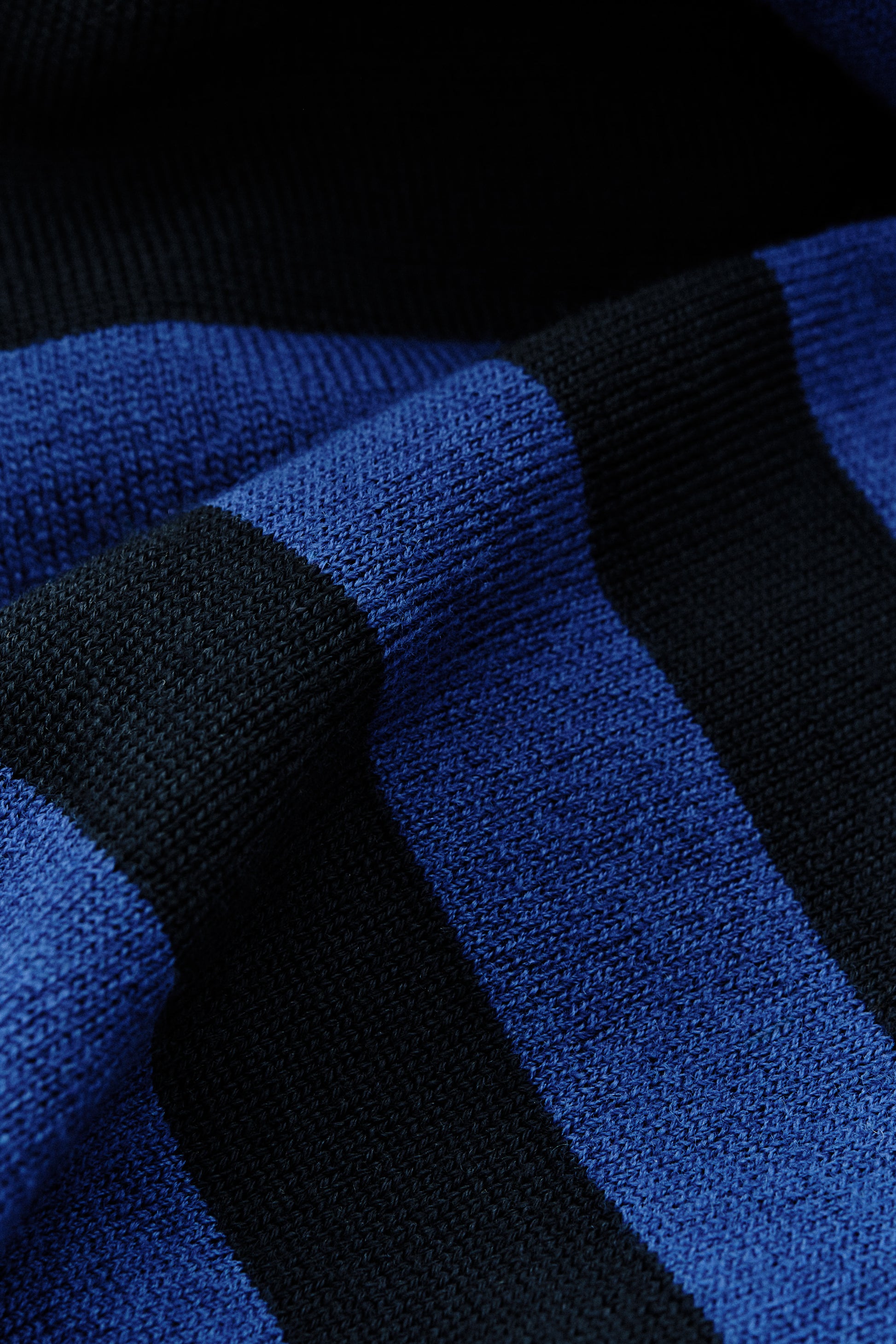 Men's knit short-sleeved polo shirt, 100% fine merino wool, black and blue striped.