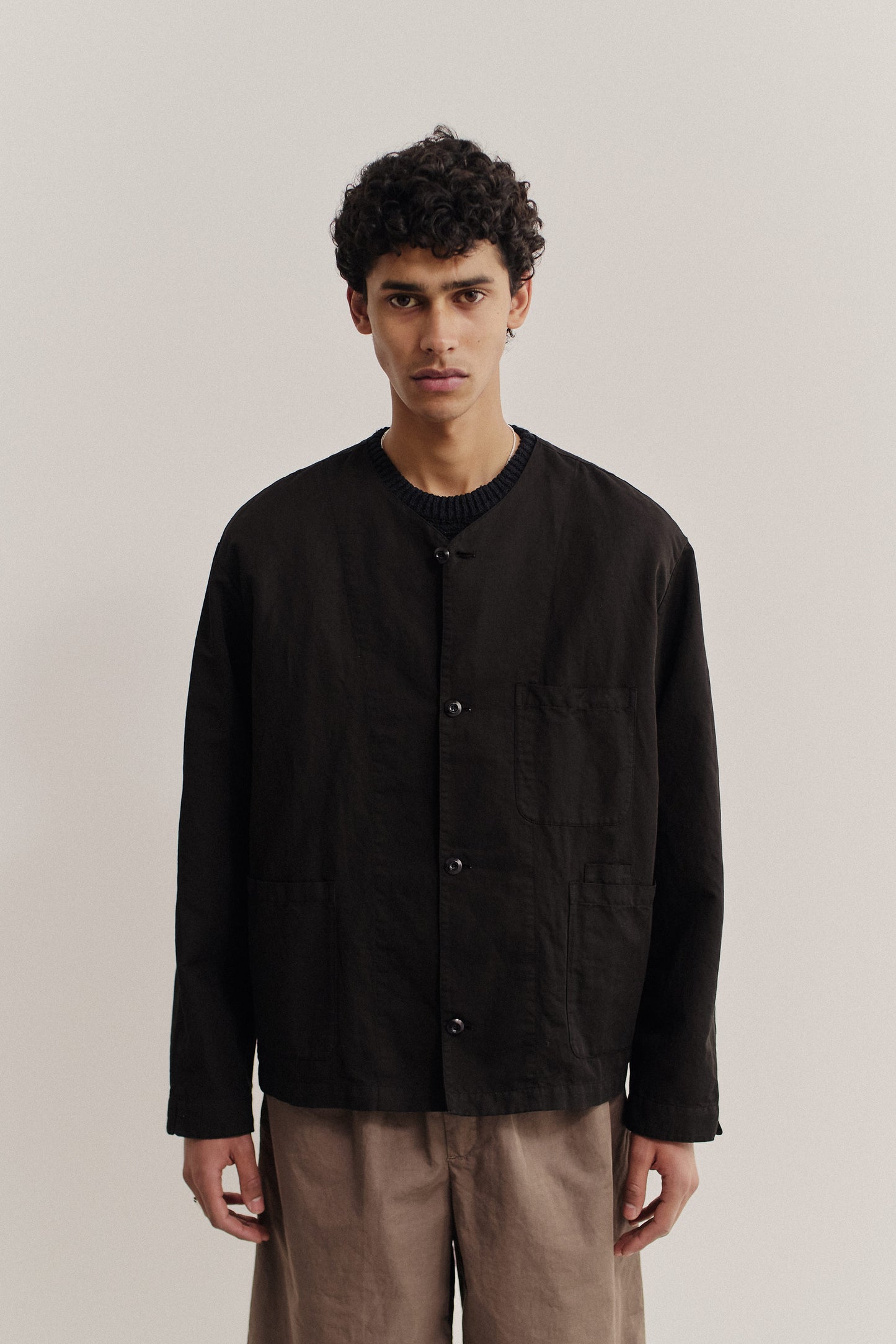 Men's long-sleeved overshirt, linen-cotton blend, garment-dyed deep black, with patch pockets and v-neck.