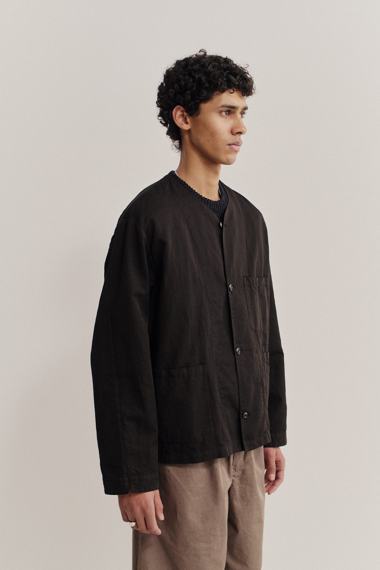 Men's long-sleeved overshirt, linen-cotton blend, garment-dyed black, with v-neck and patch pockets.