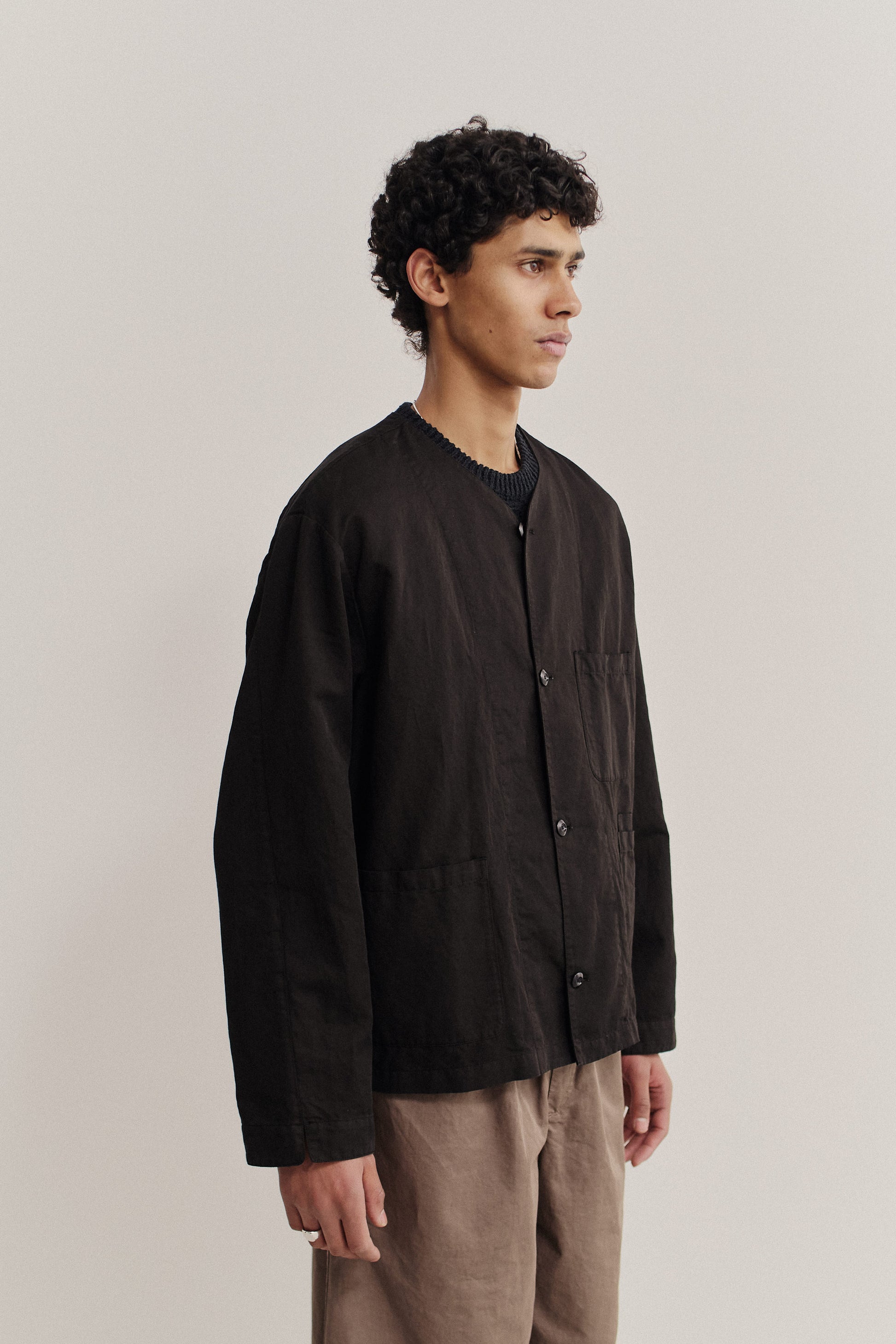 Men's long-sleeved overshirt, linen-cotton blend, garment-dyed black, with v-neck and patch pockets.
