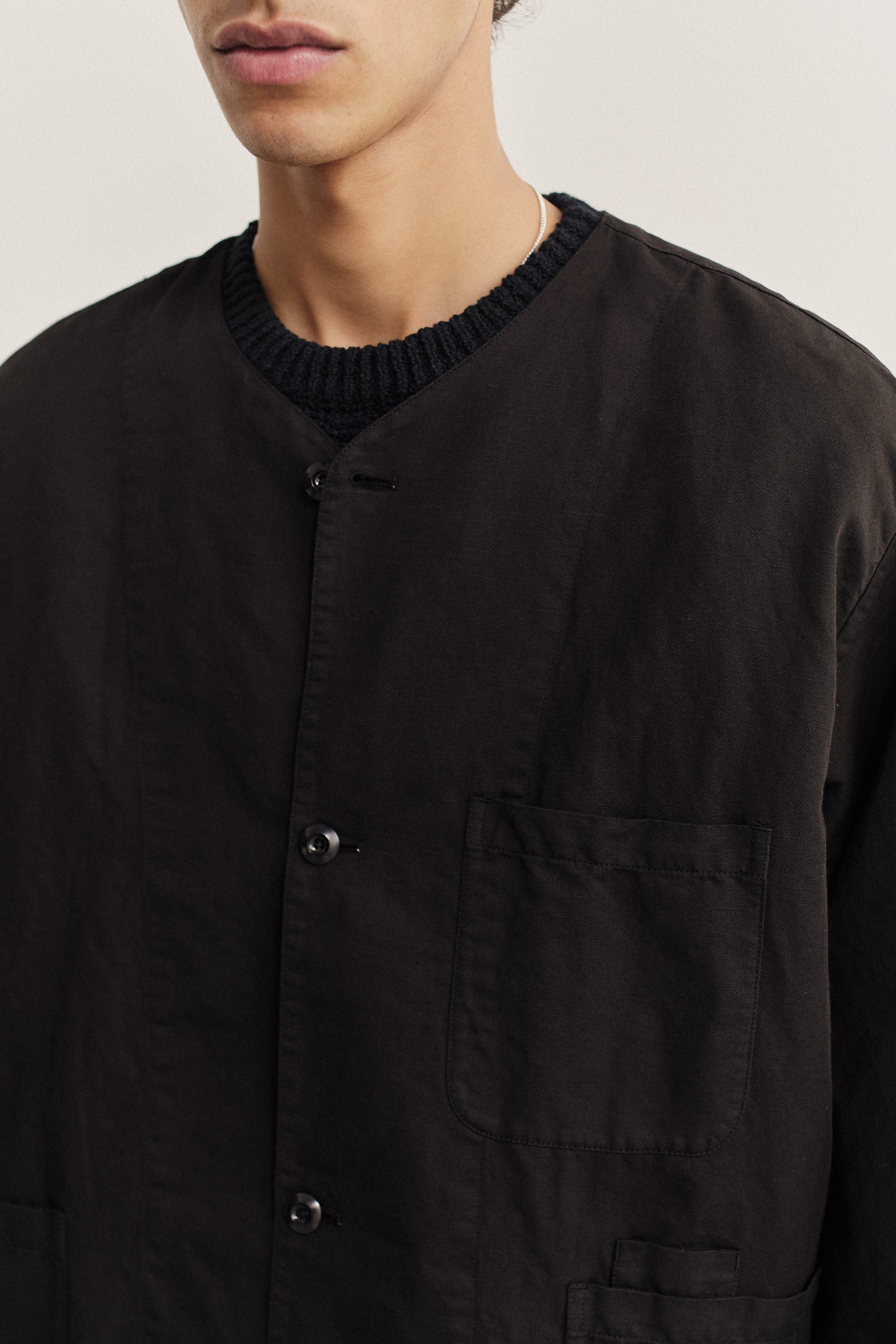 Men's long-sleeved overshirt, linen-cotton blend, garment-dyed deep black, with patch pockets and button closure.