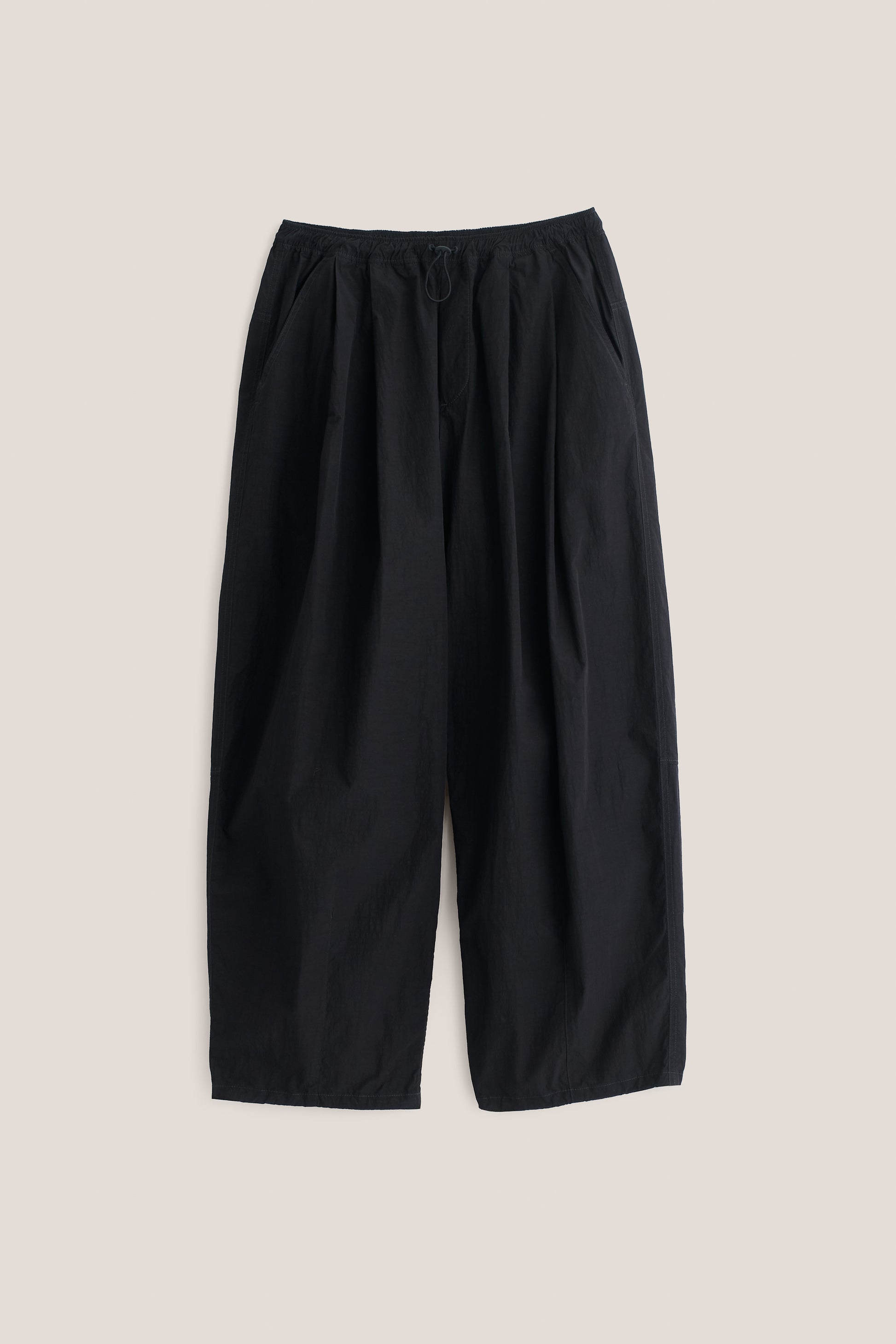 Men's long pants, black recycled nylon and cotton blend, water-repellent, relaxed fit with elastic waist.
