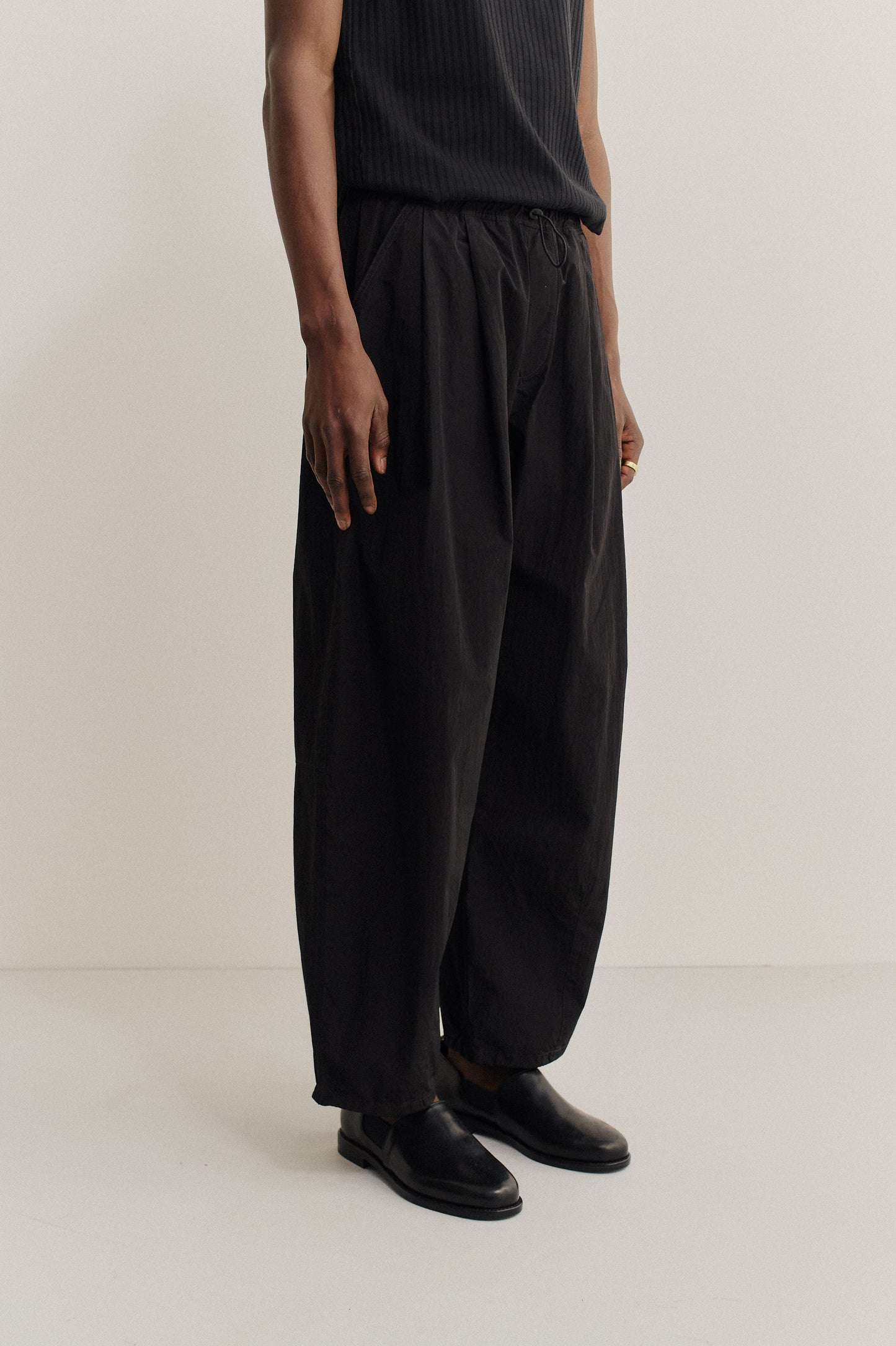 Men's long-pants, recycled nylon and cotton blend, black, relaxed fit, elastic waist, ankle length.
