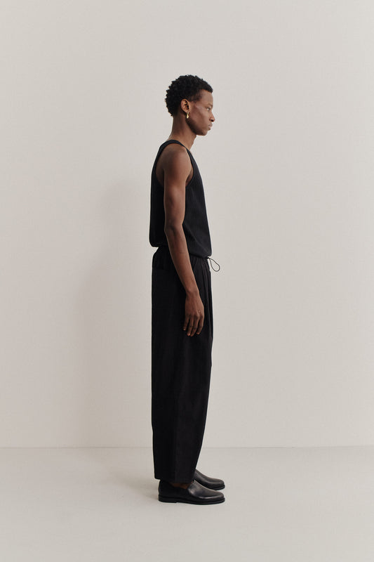 Men's long-pants, recycled nylon and cotton blend, black, relaxed fit, elastic waist, ankle length.