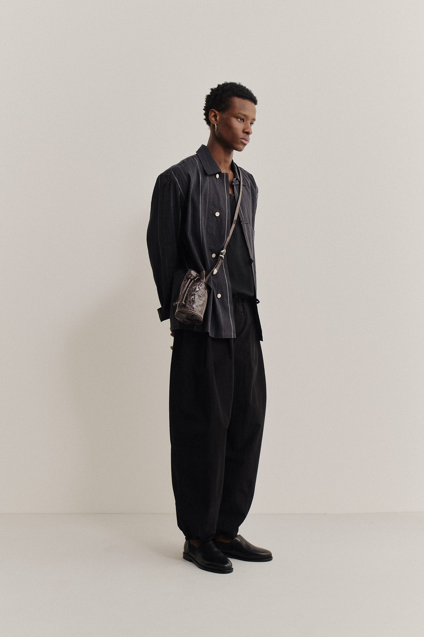 Men's long-pants, recycled nylon and cotton blend, black, relaxed fit, elastic waist, ankle length.