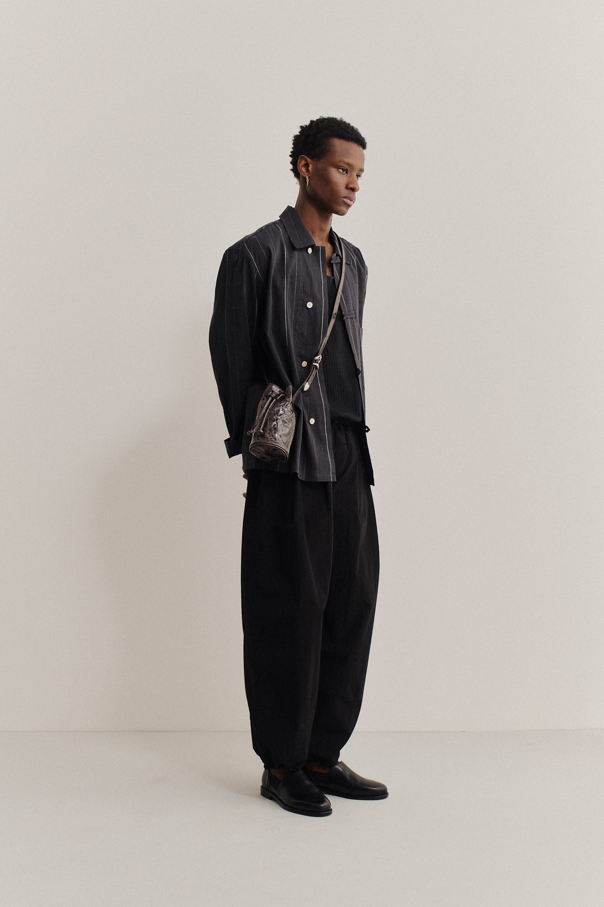 Men's long-pants, recycled nylon and cotton blend, black, relaxed fit, elastic waist, ankle length.