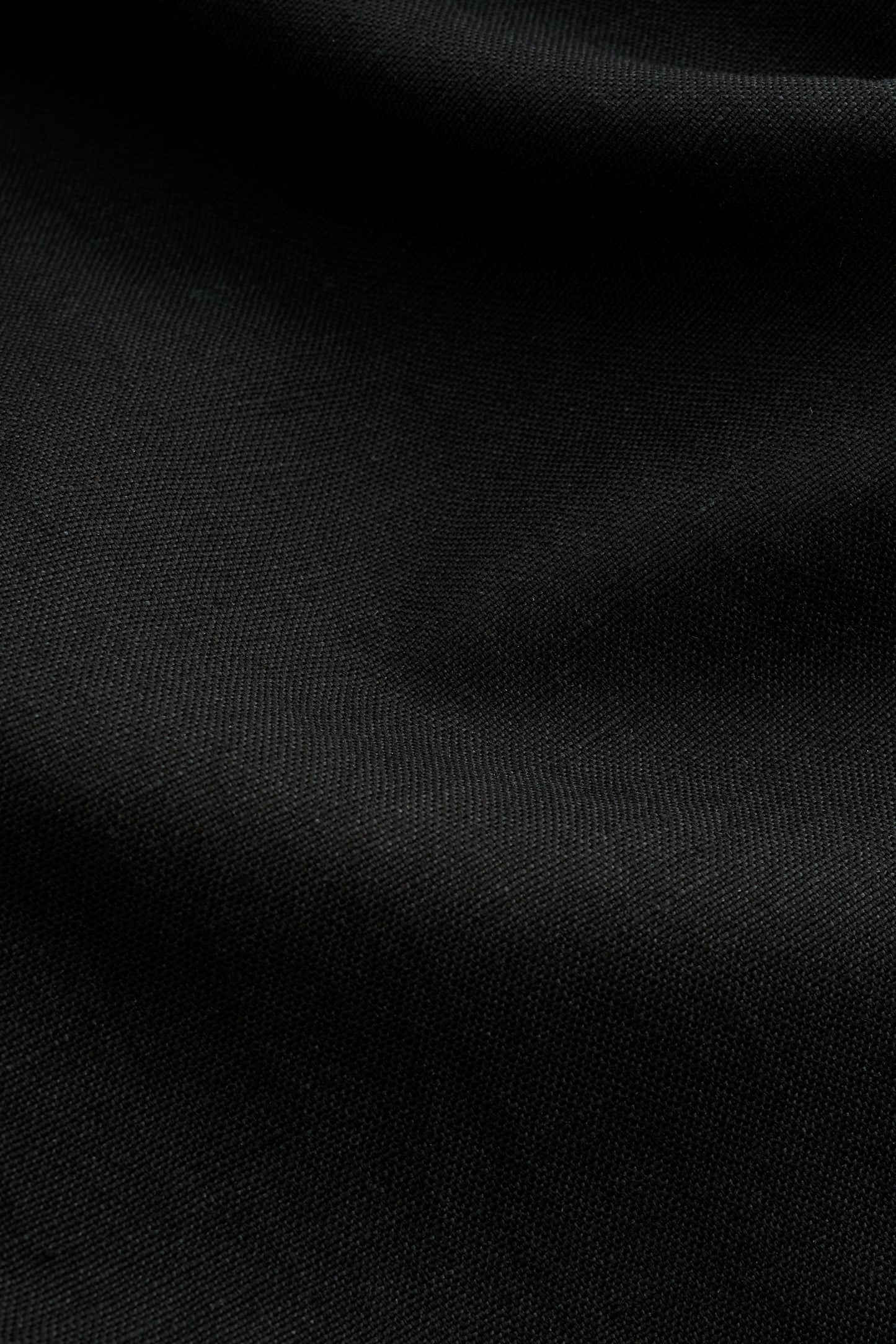 Women's dress, black worsted wool and linen blend fabric with subtle visual depth.