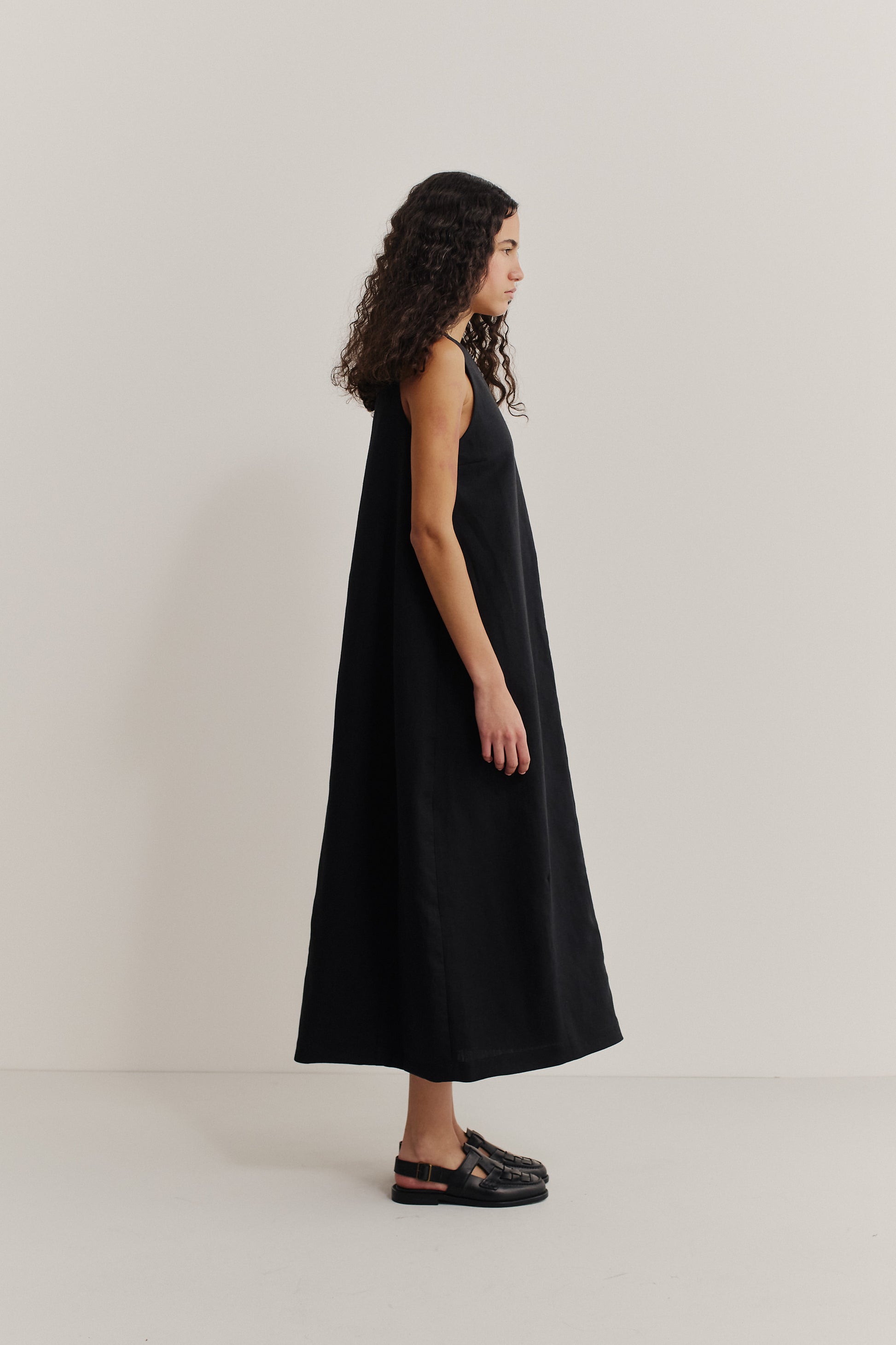 Women's dress, black worsted wool and linen blend, loose O-shaped silhouette, round front neckline, deep V-back.