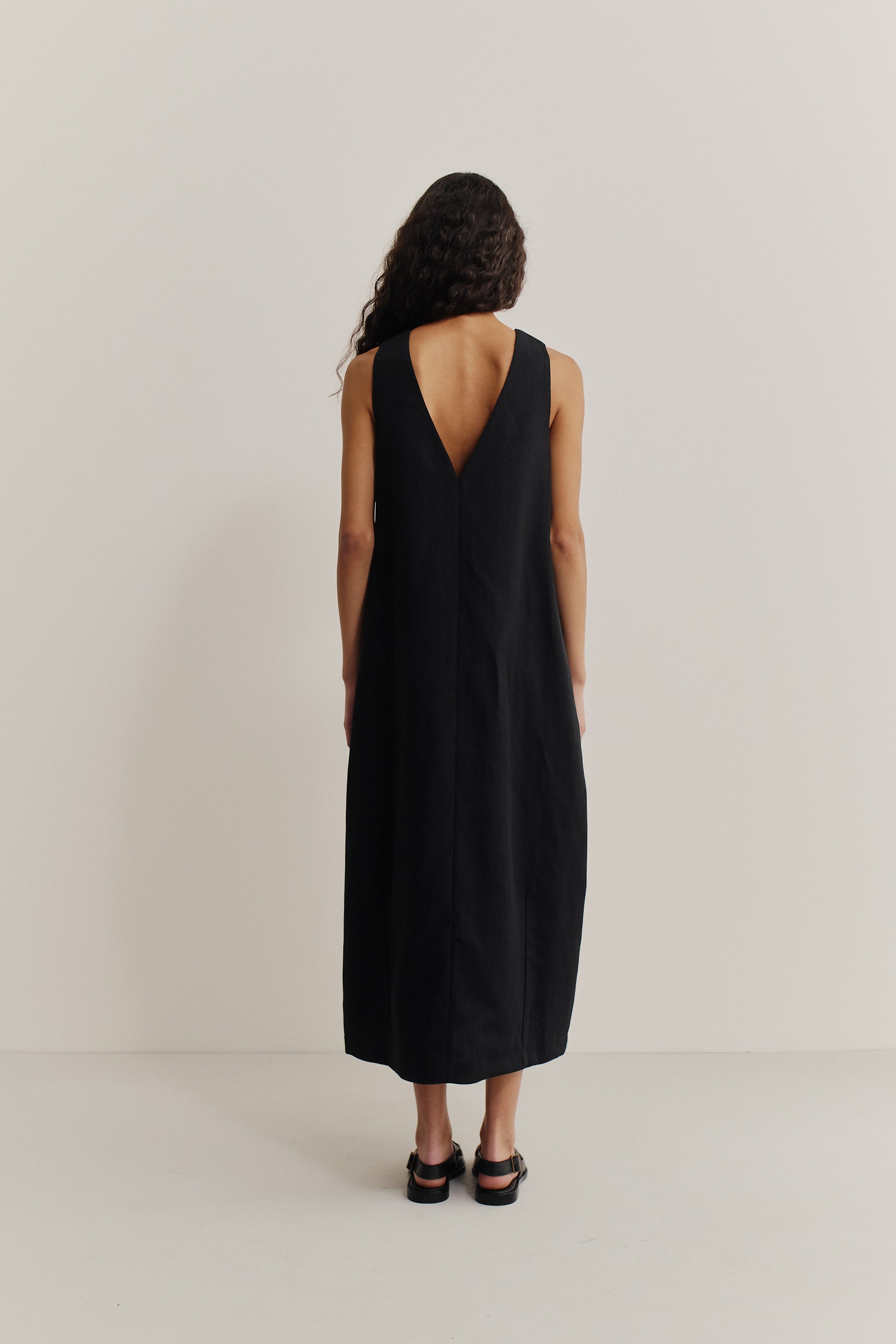 Women's dress, black worsted wool and linen blend, oversized O-shaped silhouette, deep V-neckline at back.