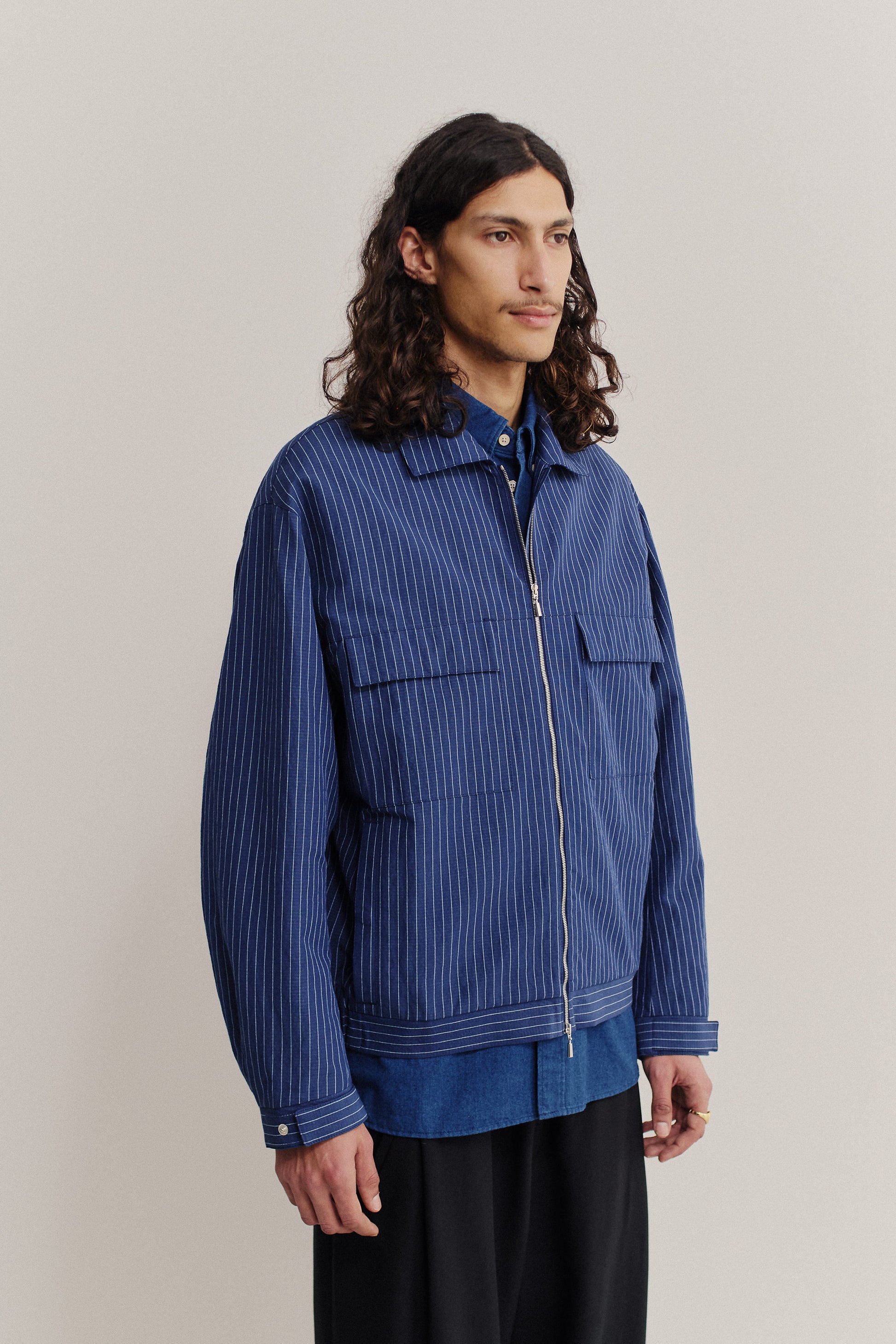 Men's outerwear jacket, cotton-linen seersucker, blue with pinstripes, boxy silhouette, flap pockets, front zip.