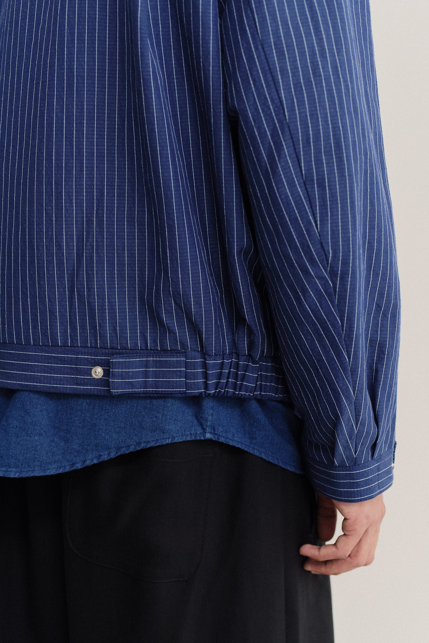 Men's outerwear jacket, cotton-linen seersucker with fine pinstripes, navy, elasticated waist, and front zip.