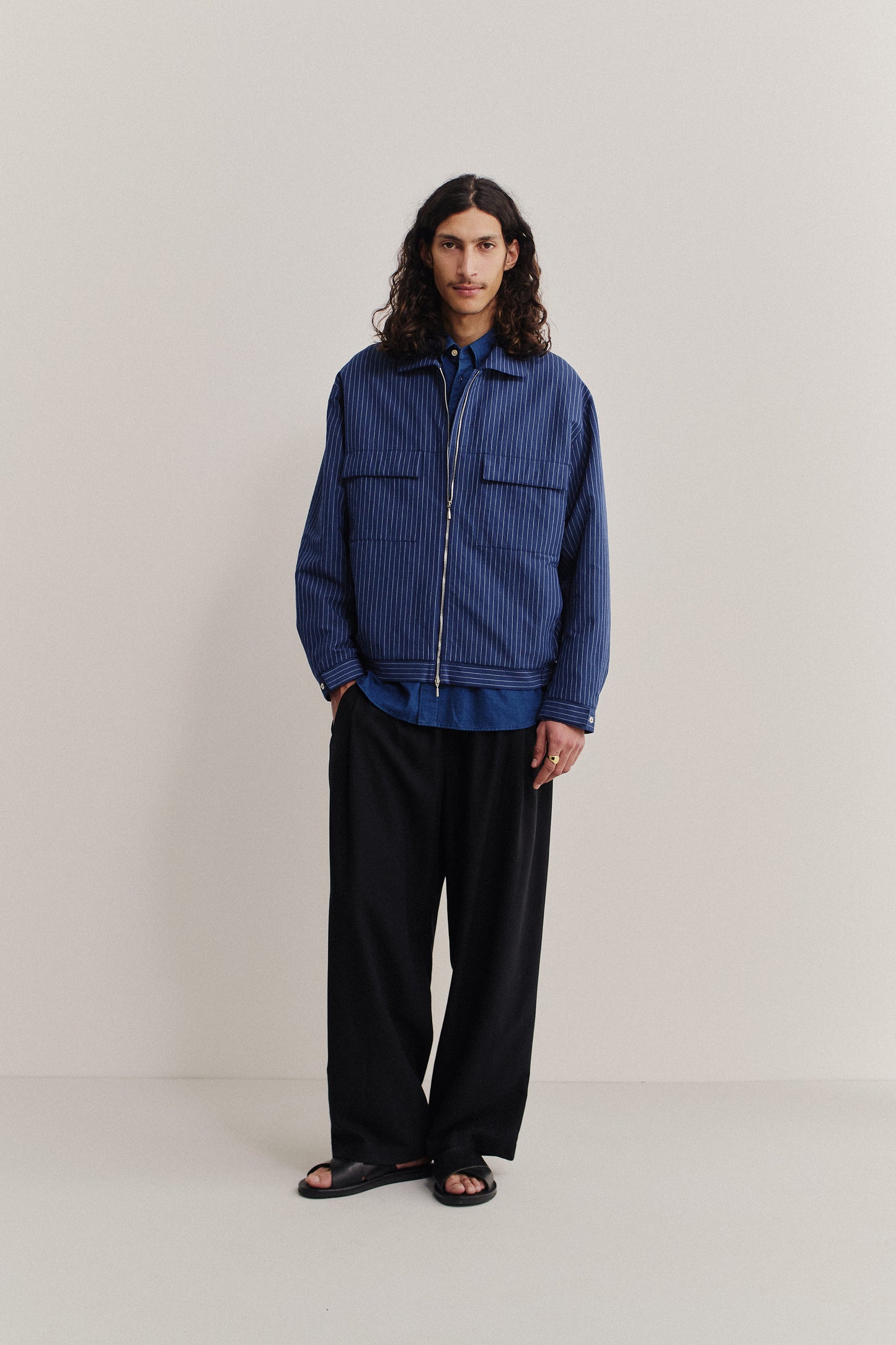 Men's outerwear jacket, cotton-linen seersucker, navy pinstripe, boxy fit, flap chest pockets, front zip.