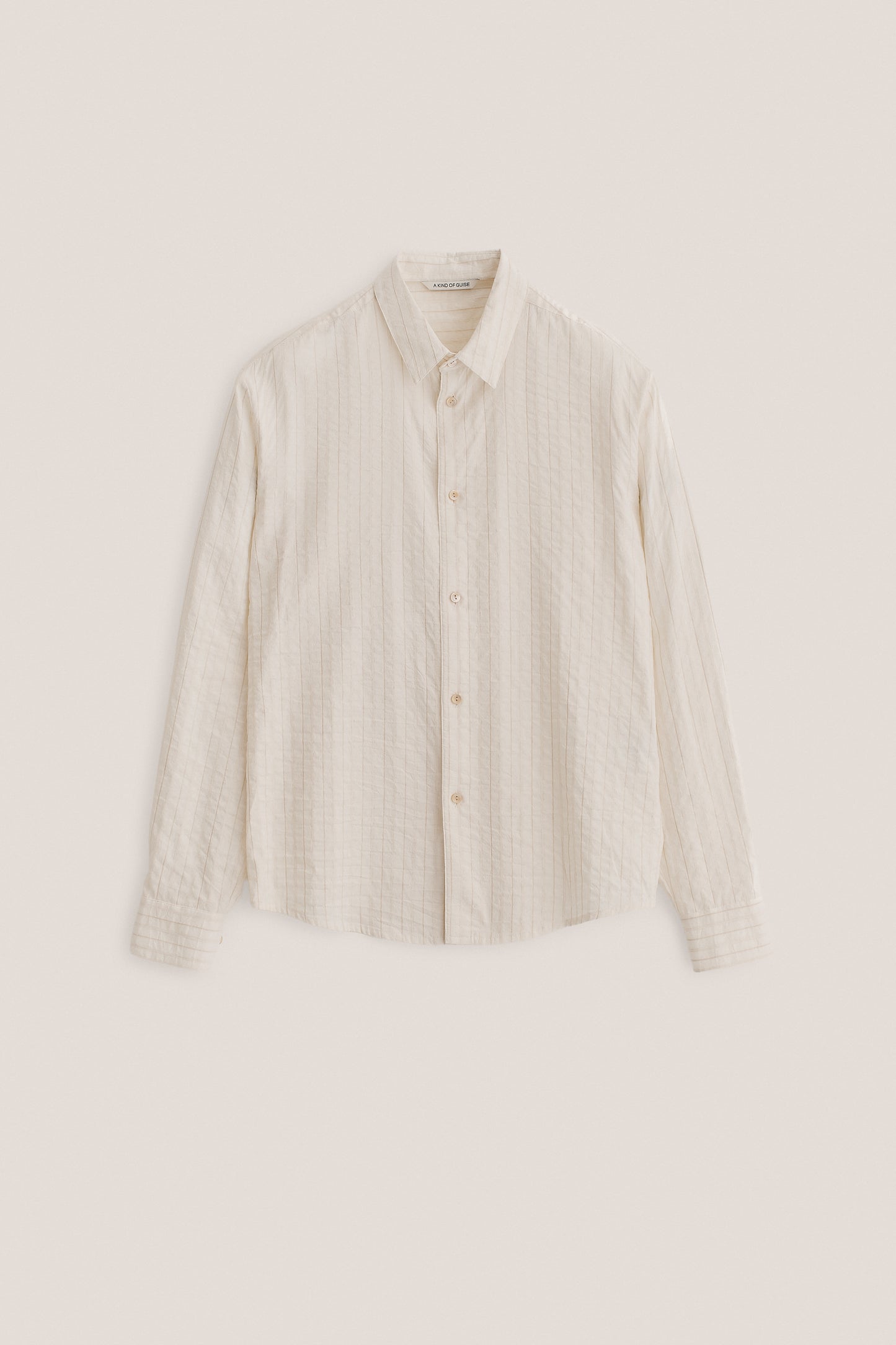 Men's long-sleeved shirt, washed cotton-silk-linen blend, off-white with subtle striped texture.