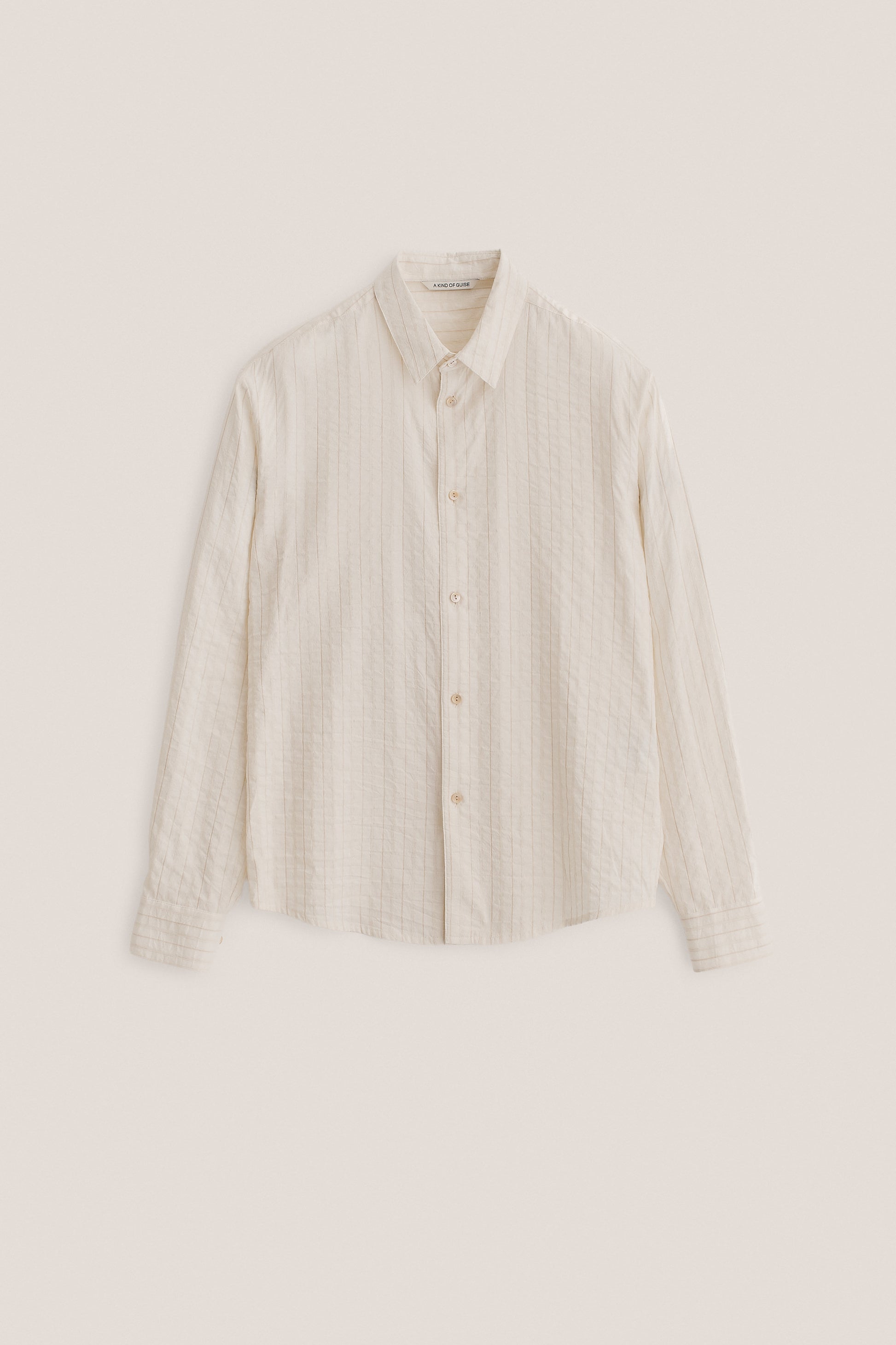 Men's long-sleeved shirt, washed cotton-silk-linen blend, off-white with subtle striped texture.
