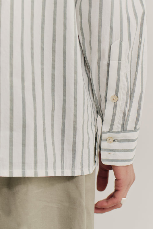 Men's long-sleeved shirt, cotton-silk-linen blend, washed white with subtle green stripes, buttoned cuff.