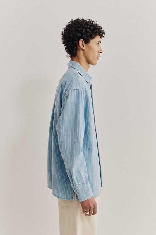 Men's long-sleeved shirt, organic cotton denim, washed light blue with pinstripes, oversized fit.