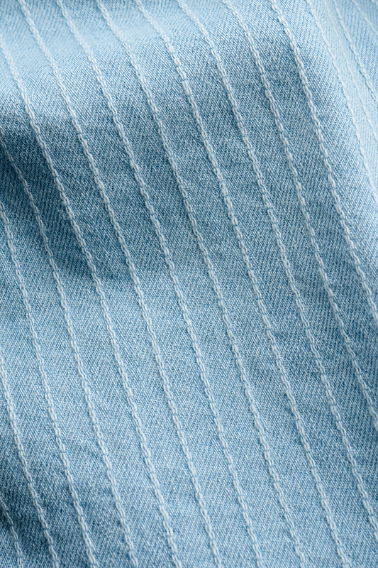 Men's long-sleeved shirt, light blue organic cotton denim with subtle white pinstripes and washed finish.