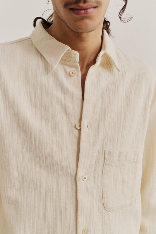 Men's long-sleeved shirt, oversized fit, recycled cotton mix, textured weave, off-white, with patch pocket and regular collar.