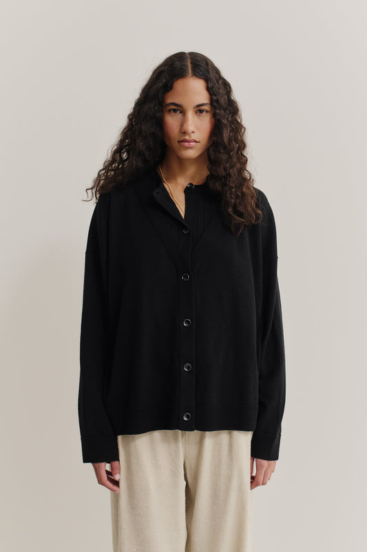 Women's knit cardigan, 100% merino wool, black, with ajour knit mock underlayer and dropped shoulders.