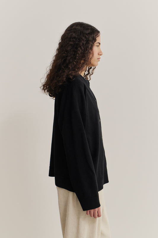 Women's knit cardigan, 100% merino wool, black, relaxed fit, deep V-neck, ajour knit pattern.