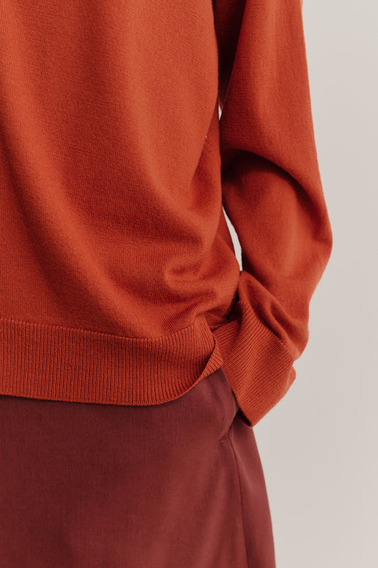Women's knit cardigan, 100% merino wool, rust orange, relaxed fit with ribbed trims.